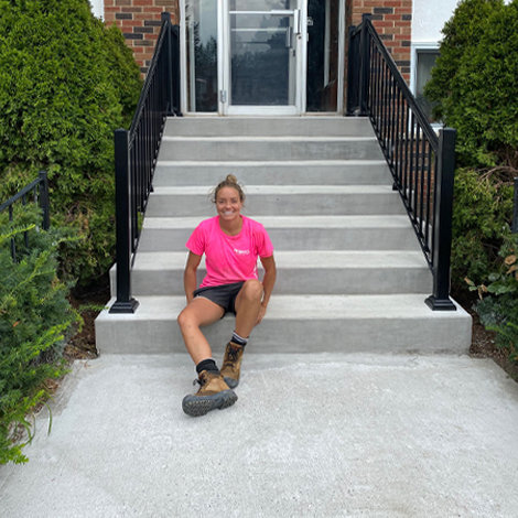 Girl sitting on concrete staircase.